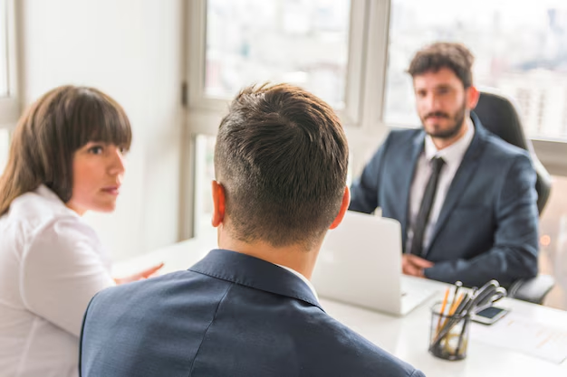 Couple in a meeting with a lawyer across an office desk