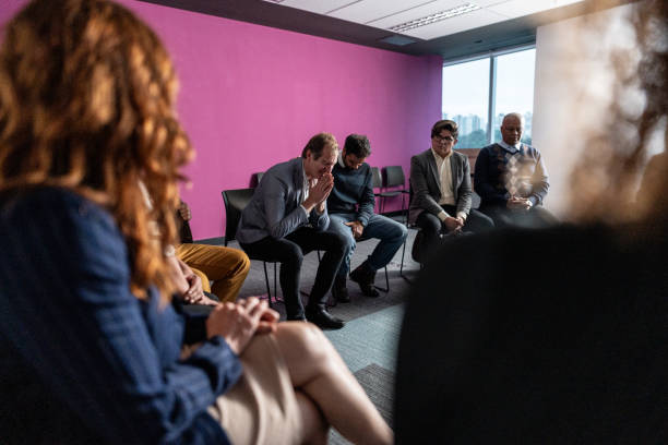 Group of people seated in a circle in a meeting room