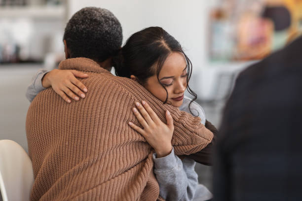 Young woman embracing an older person in a comforting hug