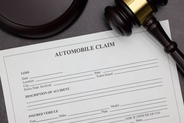 Blank Automobile Claim form beside a wooden gavel