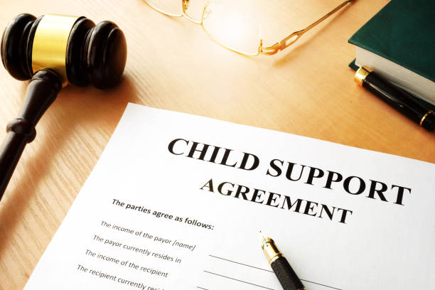 Child support agreement form beside a gavel, glasses and a pen