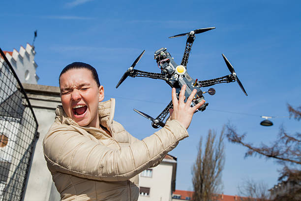 Woman shouting and shielding herself as a drone flies at her face